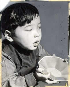 Boy with Rice Bowl++Photo of young Chinese boy, used in advertising and fundraising campaigns for the Rice Bowl Party.